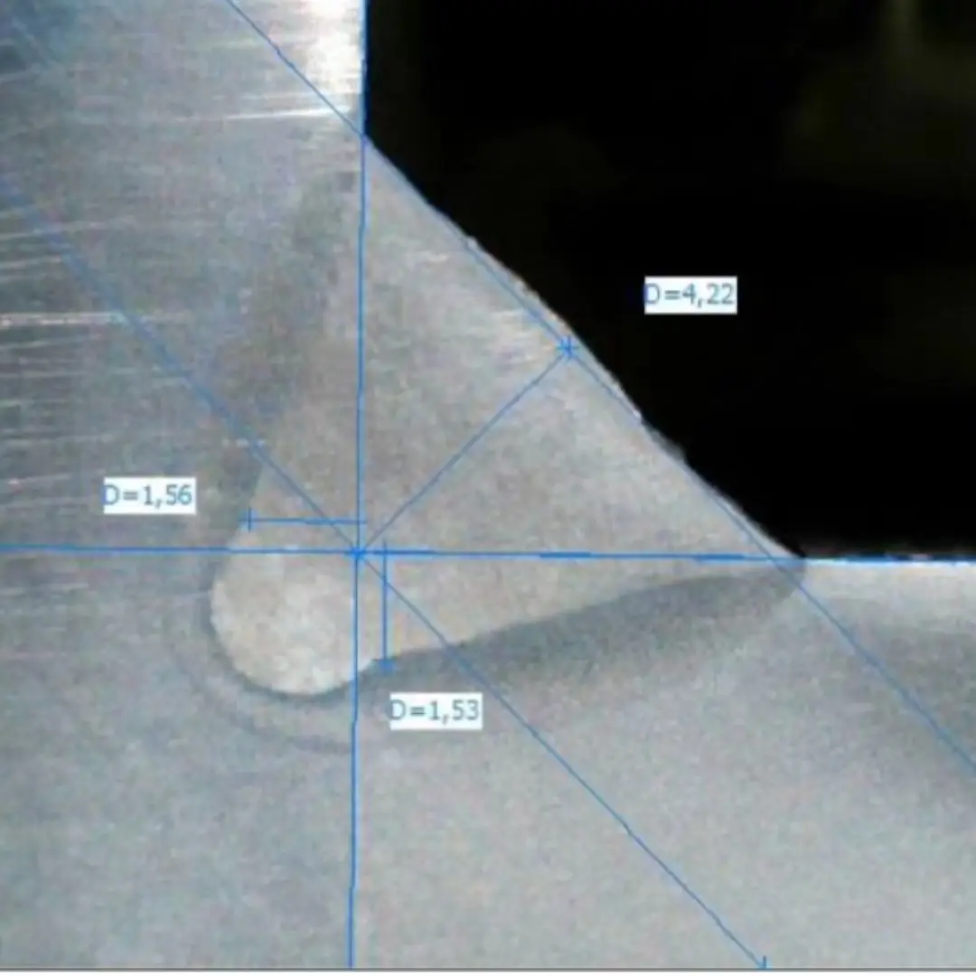 Macrograph of a fillet weld with dimensional measurements